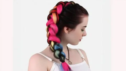 Close up of thick pink and black braided ponytail from hair braiding Bali